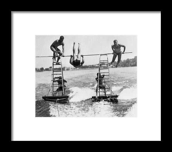 Young Men Framed Print featuring the photograph Acrobats On Lake by Bettmann