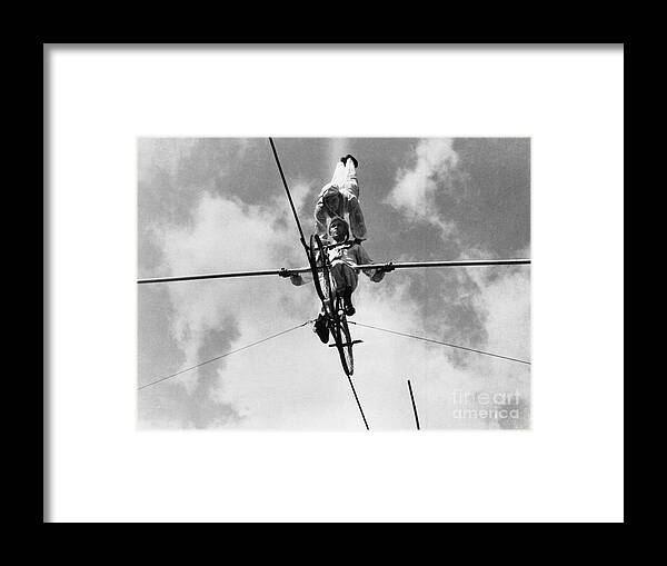 Young Men Framed Print featuring the photograph Acrobats On Tightrope, Low Angle View by Bettmann