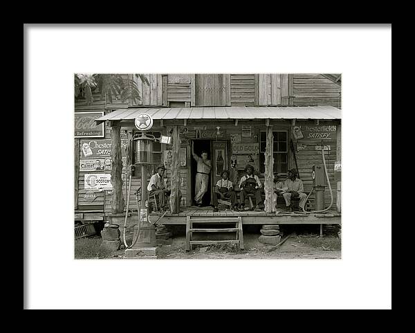 African Framed Print featuring the painting African American and a white store owner on the Porch of a country store by 
