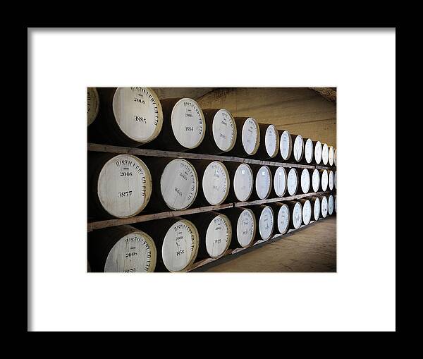 Aging Process Framed Print featuring the photograph Ageing Whisky Barrels In Distillery by Monty Rakusen