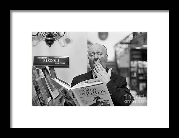 Alfred Hitchcock Framed Print featuring the photograph Alfred Hitchcock Yawning Over Book by Bettmann
