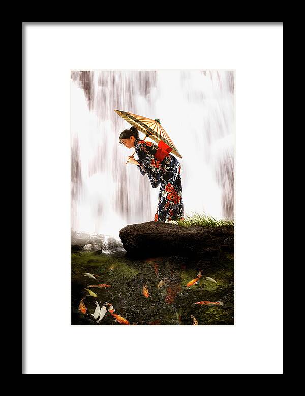 Tranquility Framed Print featuring the photograph Asian Woman In Geisha Dress Holding by Colin Anderson Productions Pty Ltd