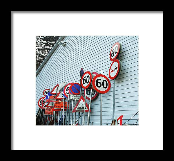 Large Group Of Objects Framed Print featuring the photograph Assorted Road Signs Stacked Against by Kjerstin Gjengedal