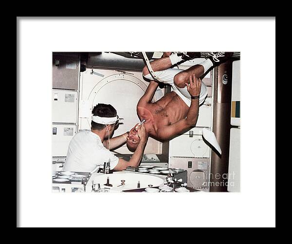 People Framed Print featuring the photograph Astronaut Gets Upside-down Oral Exam by Bettmann
