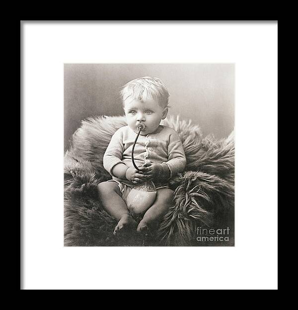 Rug Framed Print featuring the photograph Baby Boy On Bear Rug Sucking On Milk by Bettmann