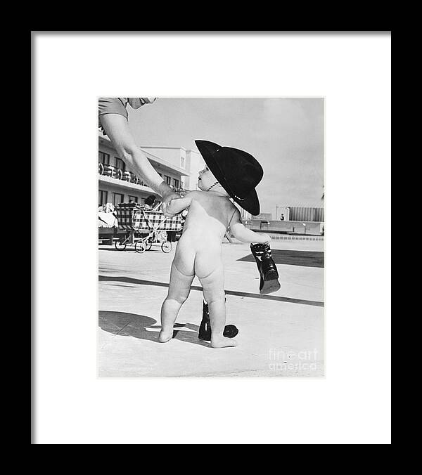 Toddler Framed Print featuring the photograph Baby Girl Wearing A Cowboy Hat by Bettmann