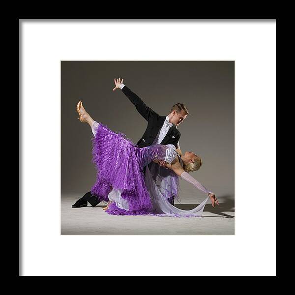 Teamwork Framed Print featuring the photograph Ballroom Dancing Pair Performing Dip by Pm Images