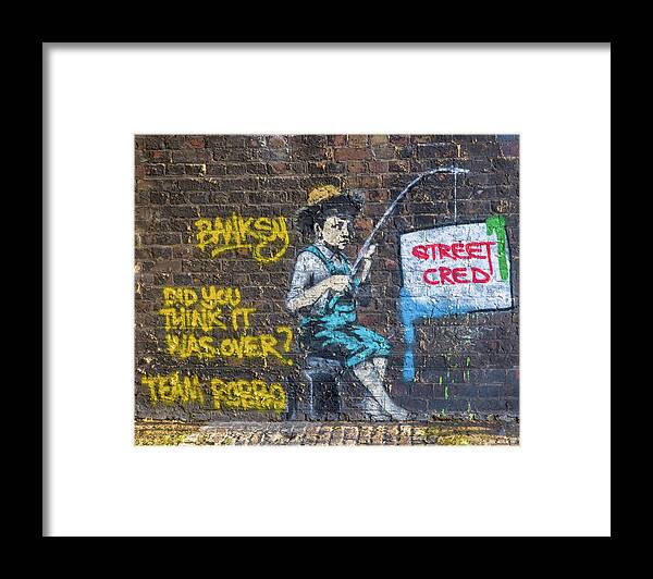 Banksy Framed Print featuring the photograph Banksy Boy Fishing Street Cred by Gigi Ebert