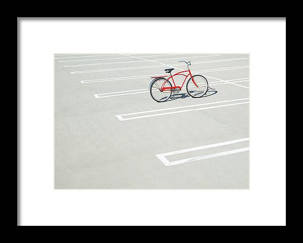 Out Of Context Framed Print featuring the photograph Bike In Empty Parking Lot by Peter Starman