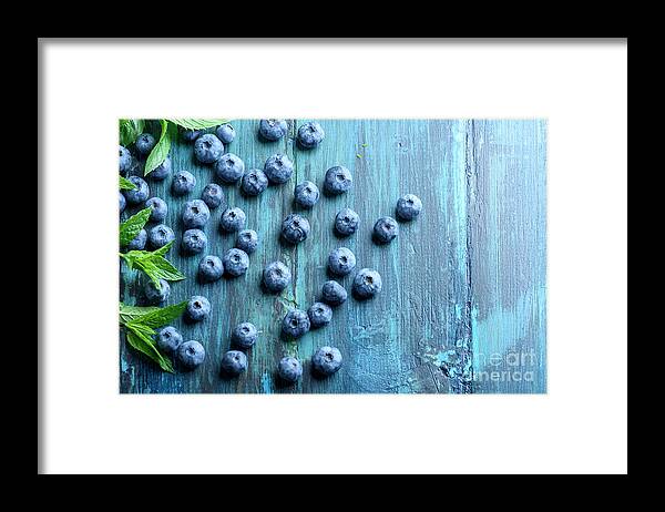 Blueberries Framed Print featuring the photograph Blueberries ion blue wooden table by Jelena Jovanovic