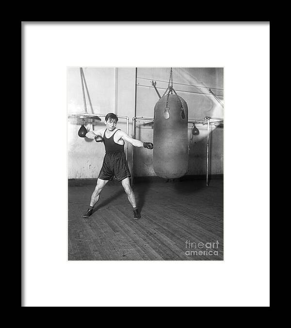 Toughness Framed Print featuring the photograph Boxer Georges Carpentier Working On Bag by Bettmann