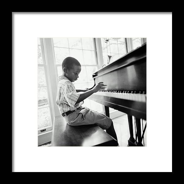 Piano Framed Print featuring the photograph Boy 6-8 Playing Piano In Home B&w by Tony Anderson