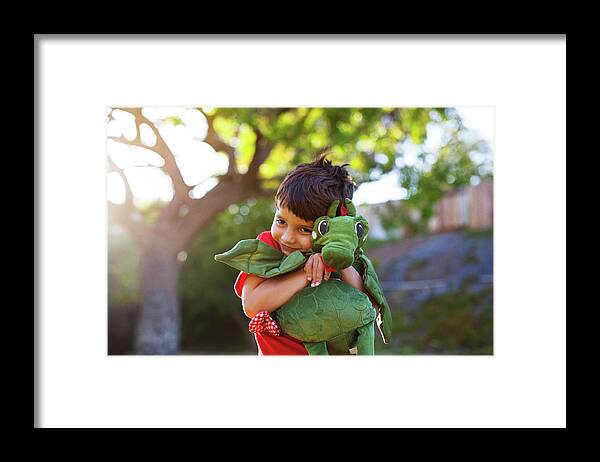 Boy Framed Print featuring the photograph Boy Embracing Stuffed Toy At Park by Cavan Images