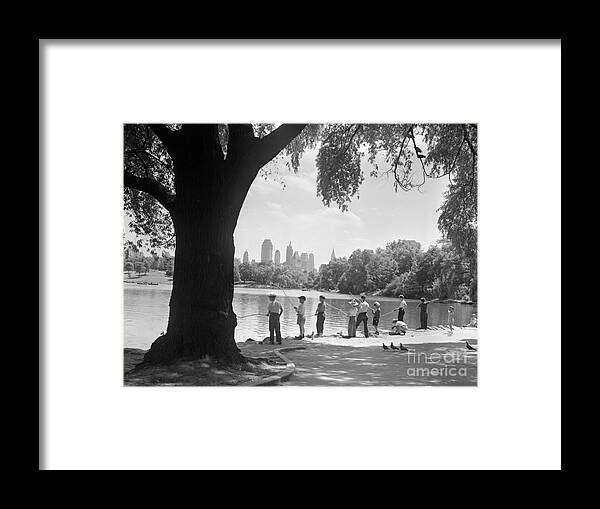 People Framed Print featuring the photograph Boys Fishing In Central Park by Bettmann