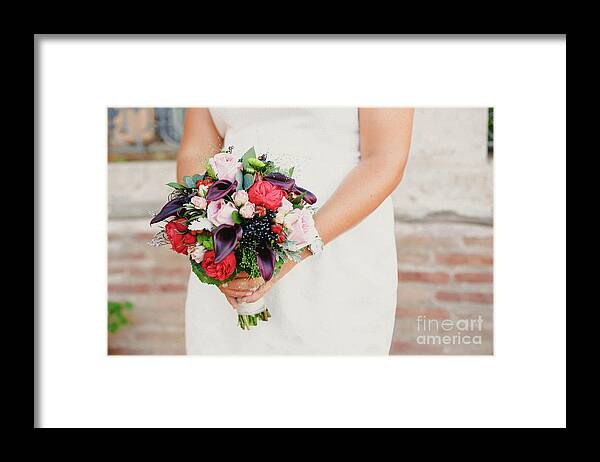 Arrangement Framed Print featuring the photograph Bridal bouquet held by her with her hands at her wedding by Joaquin Corbalan