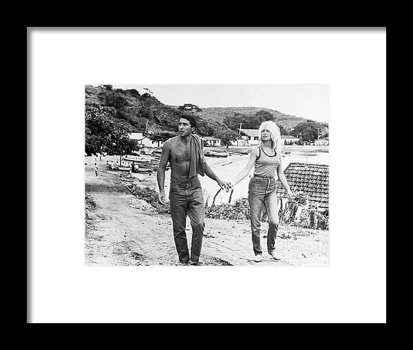 Mid Adult Women Framed Print featuring the photograph Brigitte Bardot Holding Hands With Bob by Bettmann