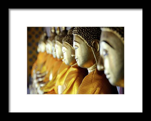 In A Row Framed Print featuring the photograph Buddhas At Wat Arun, Bangkok by Leontura