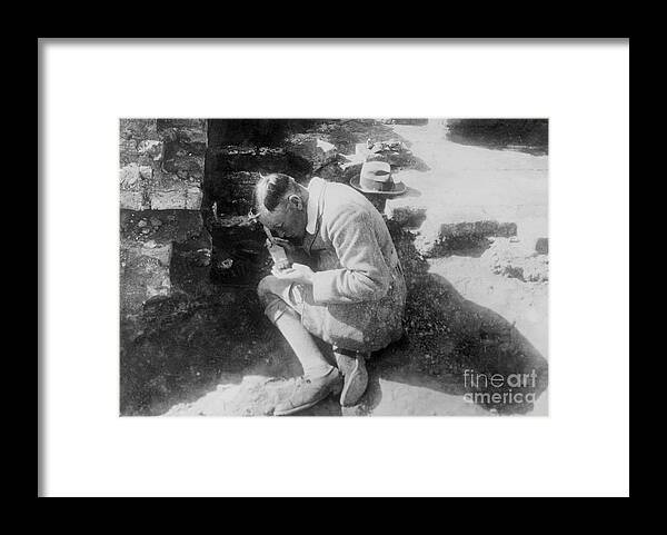 People Framed Print featuring the photograph C Leonard Woolley Brushing Off Find by Bettmann
