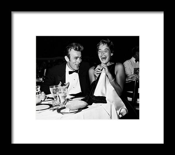#ursula_andress Framed Print featuring the photograph Candid Portrait Of James Dean And Ursula Andress Laughing At Dinner Table by Globe Photos