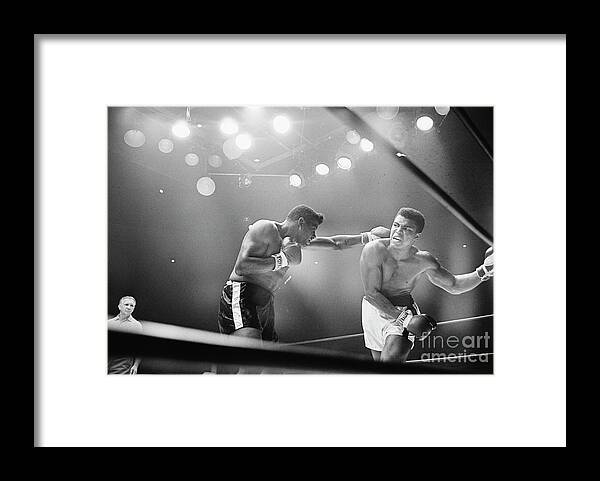 Snarling Framed Print featuring the photograph Cassius Clay Snarling At Floyd Patterson by Bettmann