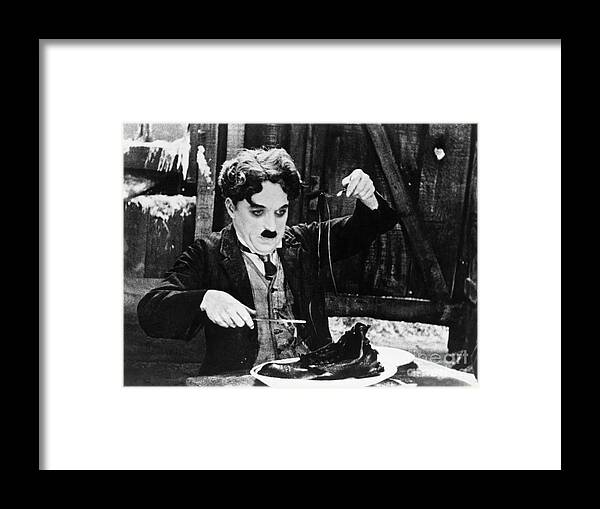 Charlie Chaplin Framed Print featuring the photograph Charlie Chaplin In The Shoe-eating by Bettmann