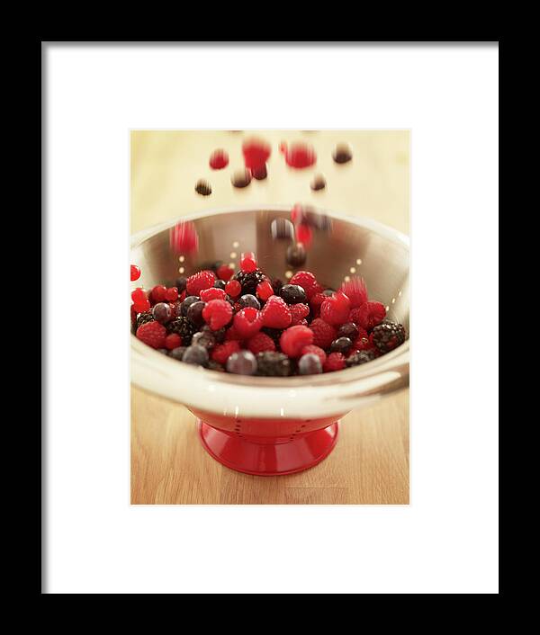 Blurred Motion Framed Print featuring the photograph Close Up Of Berries Falling Into Red by Adam Gault
