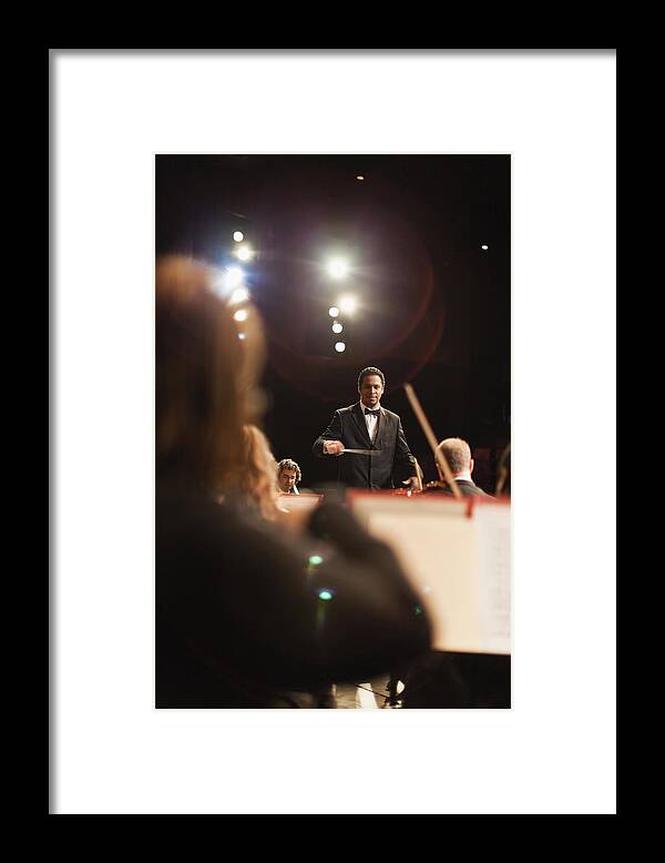 People Framed Print featuring the photograph Conductor Waving Baton Over Orchestra by Hybrid Images