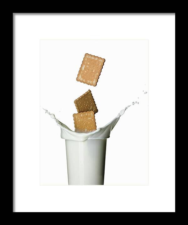 Milk Framed Print featuring the photograph Cookies Splashing Into Glass Of Milk by Walter Zerla