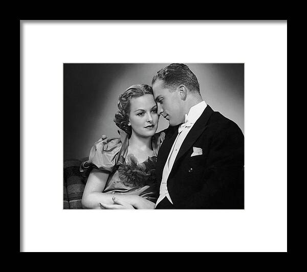 Heterosexual Couple Framed Print featuring the photograph Couple Dressed Up Cuddling by George Marks