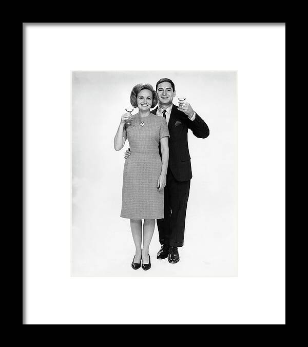 Heterosexual Couple Framed Print featuring the photograph Couple Drinking Champagne by George Marks
