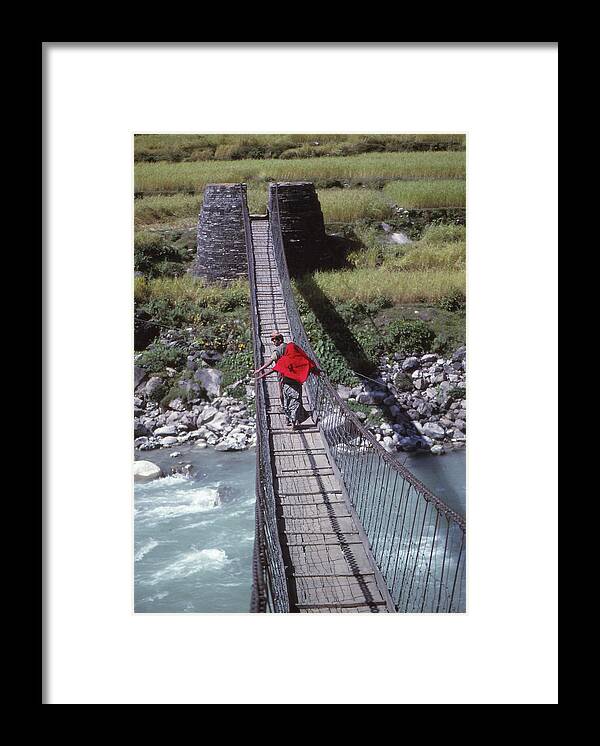 Nepal Framed Print featuring the photograph Crossing a suspension bridge by Steve Estvanik
