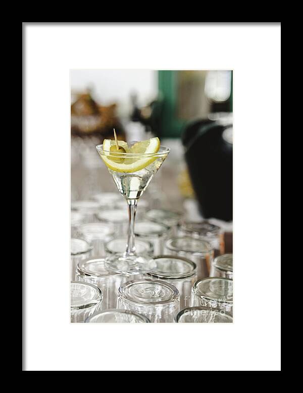Alcohol Framed Print featuring the photograph Cup of gin and tonic, with a slice of lemon and olive. by Joaquin Corbalan