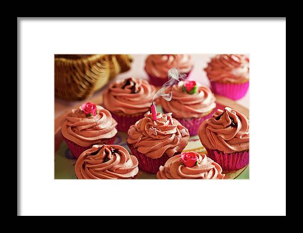 Ip_11250172 Framed Print featuring the photograph Cupcakes Decorated With Pink Buttercream Icing With A Blown Out, Smoking Candle by Jane Saunders
