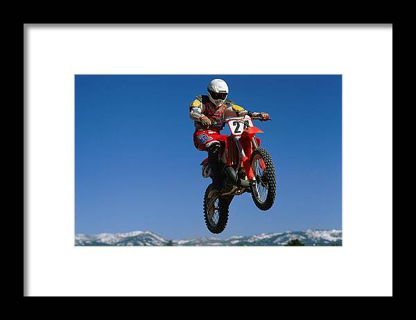 Crash Helmet Framed Print featuring the photograph Dirt Biker In Mid-air by Stockbyte