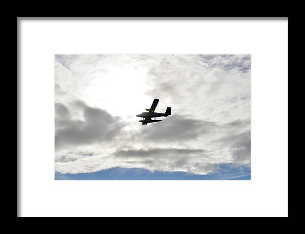 A Seaplane Is Silhouetted Against Clouds Spotlit By The Translucent Glow Of Morning Sun. Framed Print featuring the photograph Escape by Climate Change VI - Sales