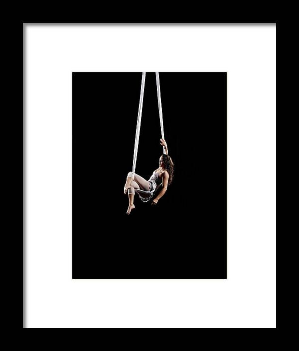 Expertise Framed Print featuring the photograph Female Aerialist Seated On Suspended by Thomas Barwick