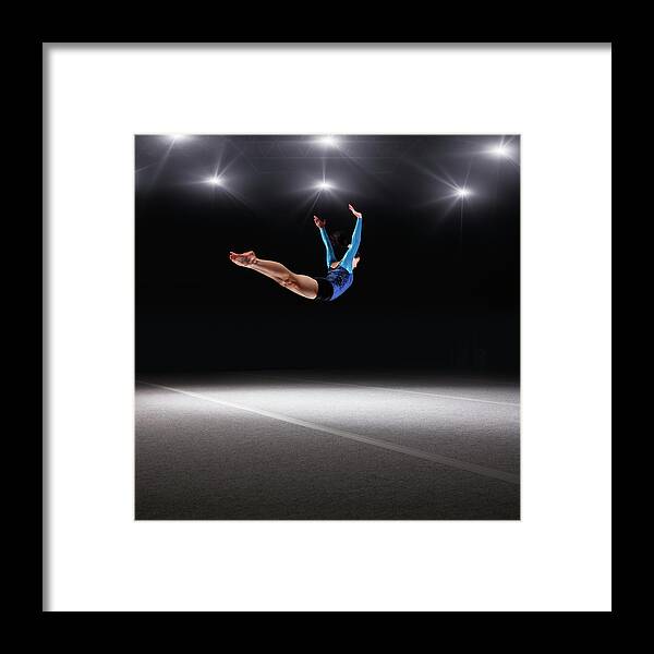 Human Arm Framed Print featuring the photograph Female Gymnast Jumping Through Air by Robert Decelis Ltd