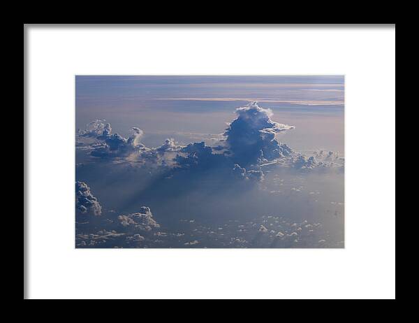 Clouds Framed Print featuring the photograph Flying above the clouds by Eric Hafner