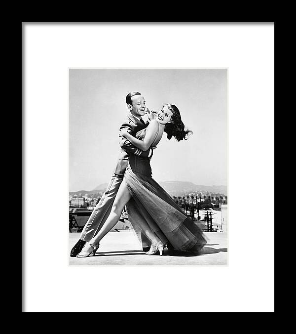 Fred Astaire Framed Print featuring the photograph FRED ASTAIRE and RITA HAYWORTH in YOU'LL NEVER GET RICH -1941-. by Album