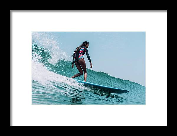 Surfer Framed Print featuring the photograph Full Body Of A Stylish Female Surfer On A Wave by Cavan Images