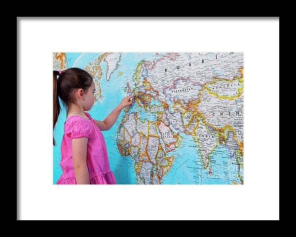 World Framed Print featuring the photograph Girl Looking At Map Of Europe by Conceptual Images/science Photo Library