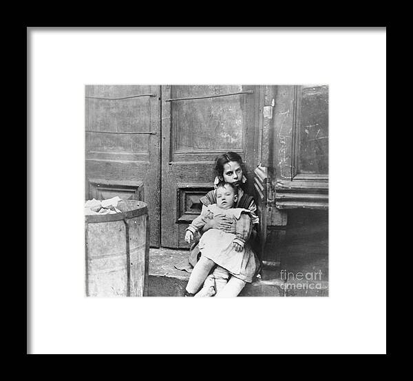 Toddler Framed Print featuring the photograph Girl Sitting On Doorstep With Baby by Bettmann