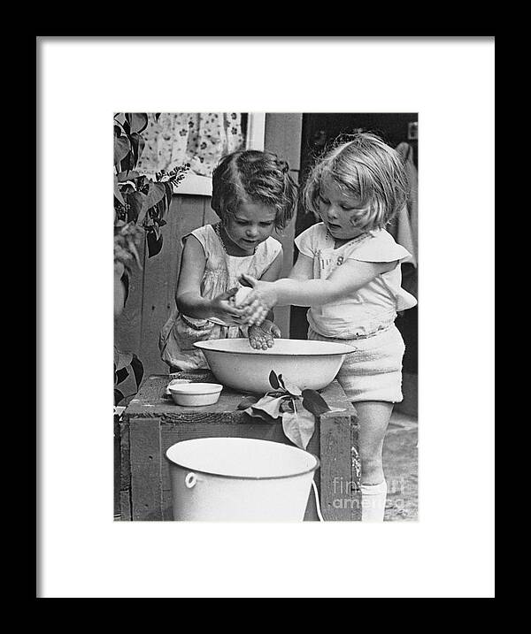 Child Framed Print featuring the photograph Girls 6-7 Washing Hands In Wash Bowl by Bettmann