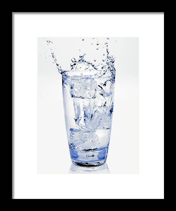 White Background Framed Print featuring the photograph Glass Of Water Splashing Around by Maria Toutoudaki
