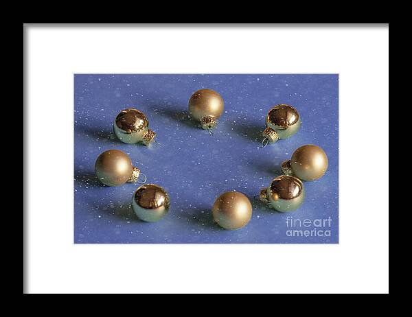 Decoration Framed Print featuring the photograph Golden christmas balls on the snowy background by Marina Usmanskaya