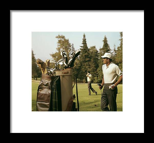 Golfer Framed Print featuring the photograph Golfers On The Course by Tom Kelley Archive