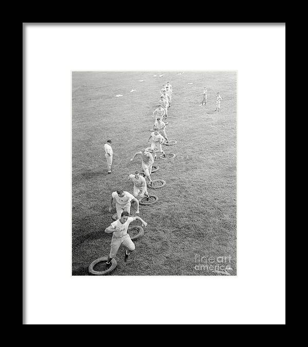 People Framed Print featuring the photograph Grid Squad Team Practicing by Bettmann