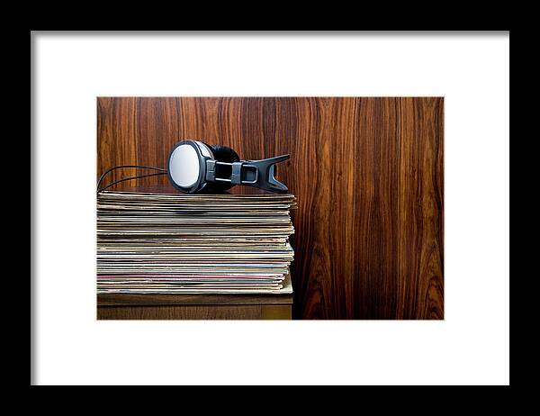 Technology Framed Print featuring the photograph Headphones Laying On Stack Of Vinyl by Steven Errico