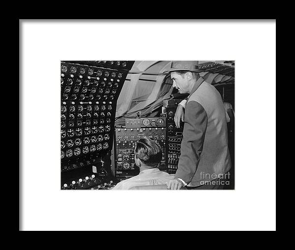 Howard Hughes Framed Print featuring the photograph Howard Hughes Checking Dials by Bettmann
