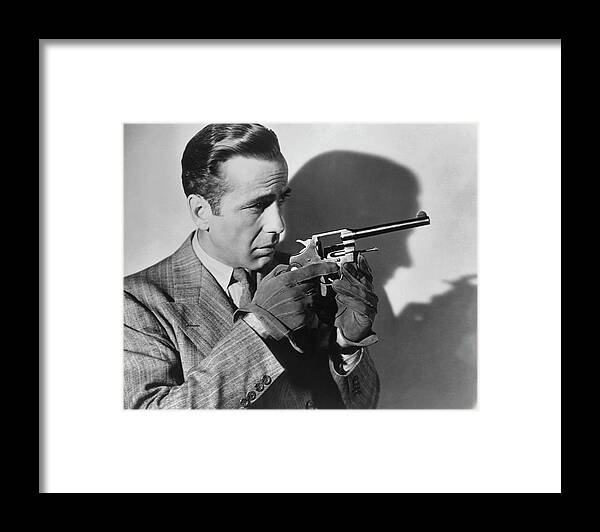 Humphrey Bogart Framed Print featuring the photograph Humphrey Bogart With A Gun by Archive Photos